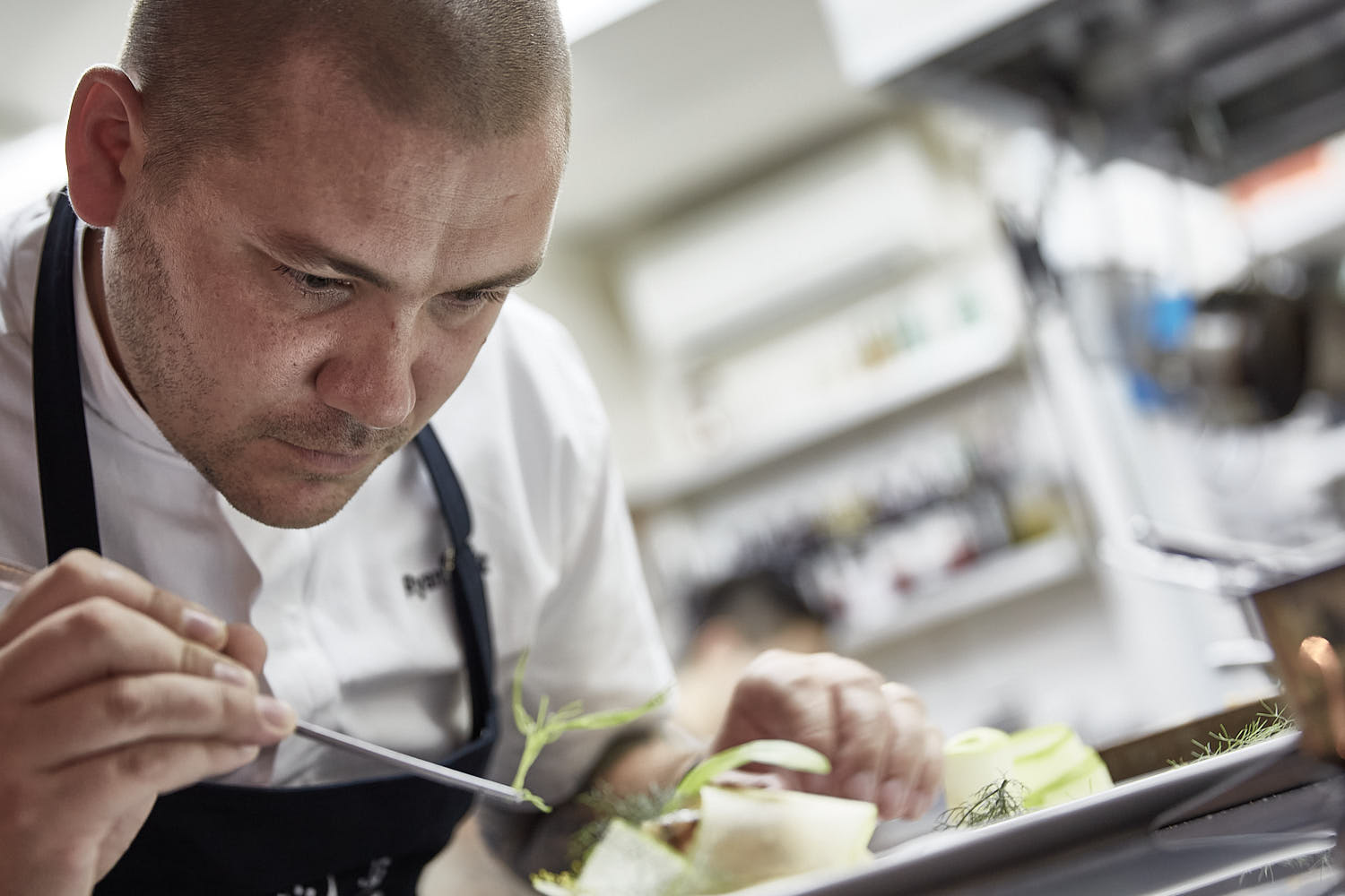 Close headshot of chef working in kitchen.