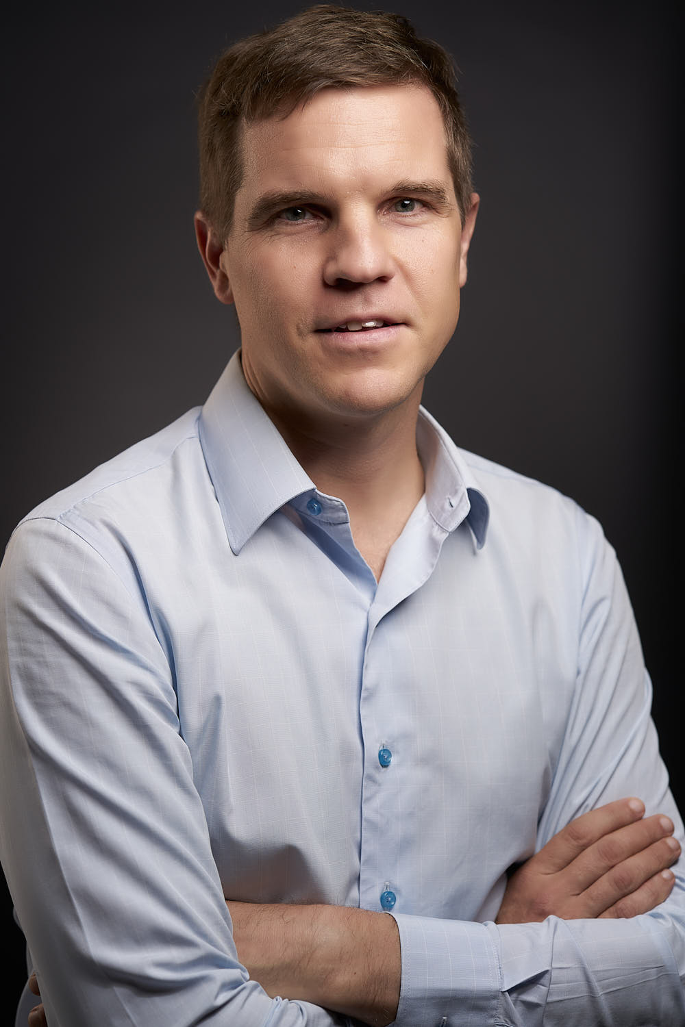 Executive team member portrait dressed in business casual.