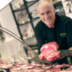 Gourmet chef smiling headshot.
