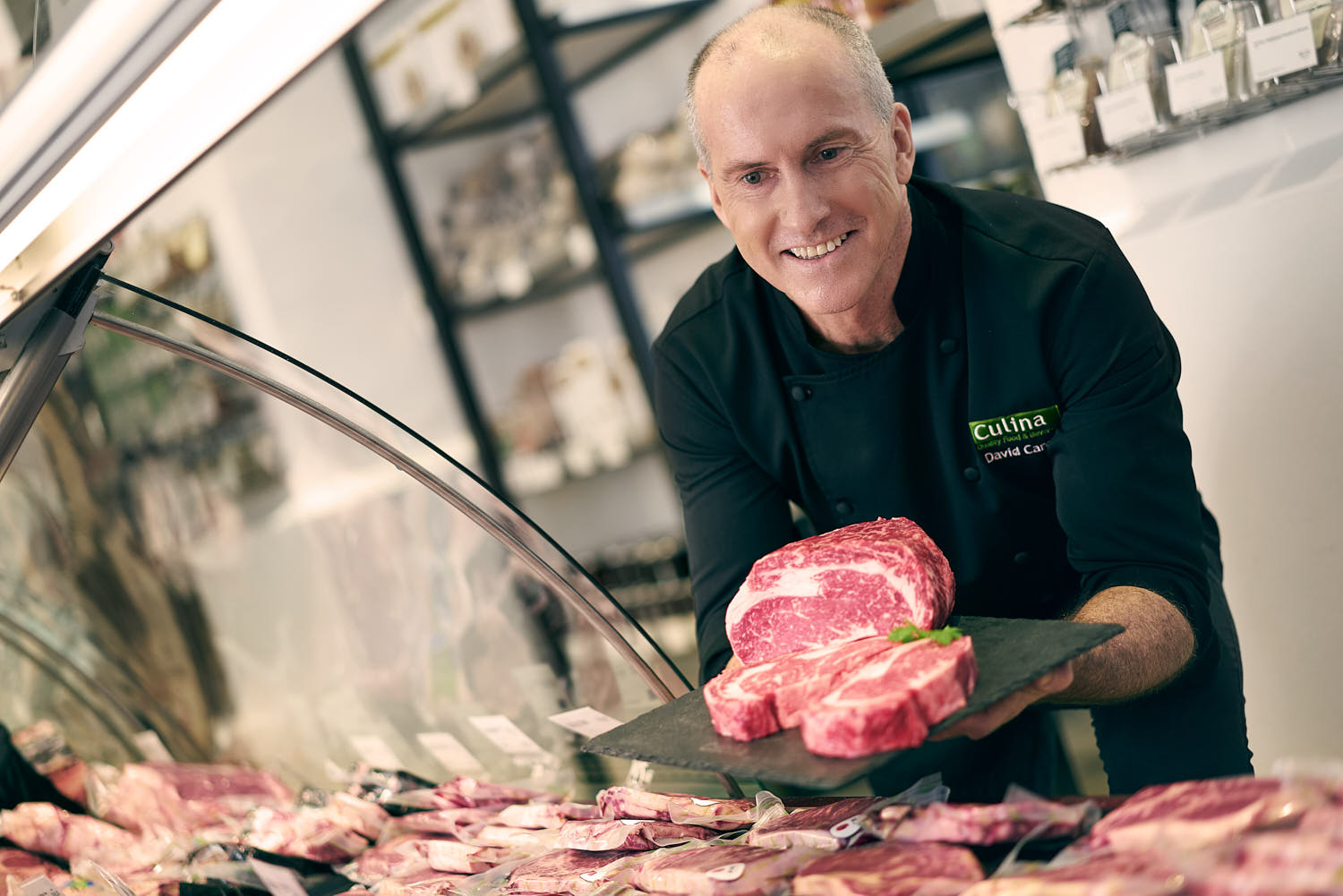 Gourmet chef smiling headshot.