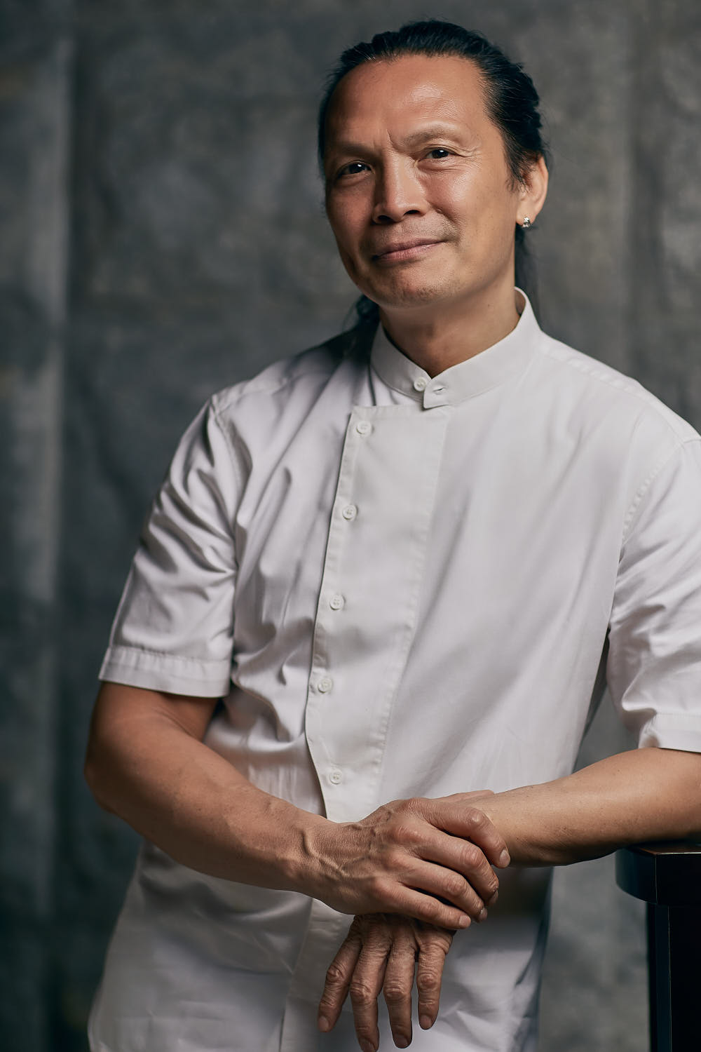 Half body portrait of celebrity chef Susur Lee in Tung Lok Heen RWS.