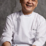 Smiling portrait of happy chef in restaurant.