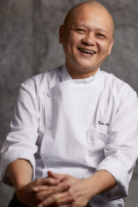 Smiling portrait of happy chef in restaurant.
