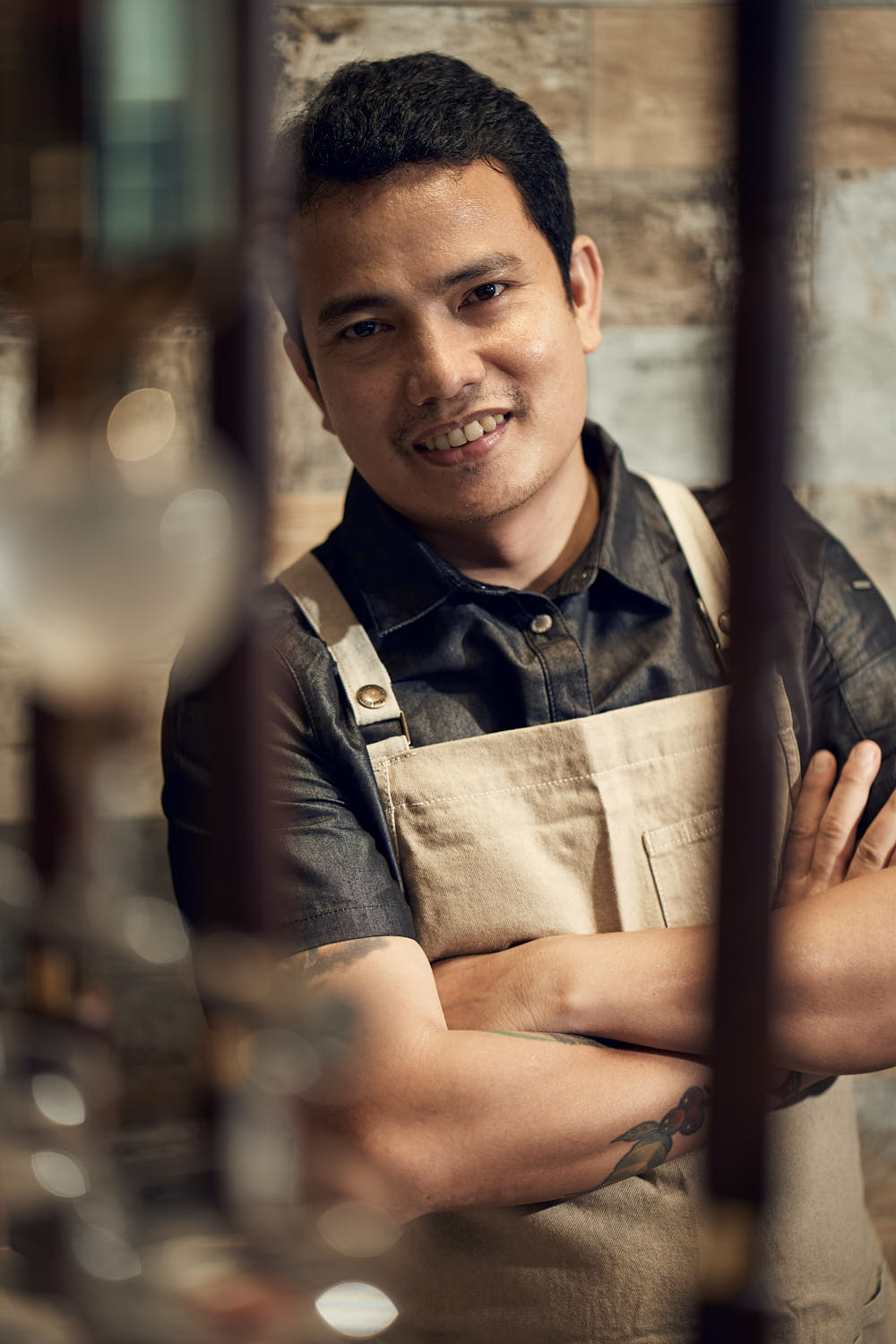 Smiling barista portrait in coffee shop.