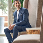 Portrait of smiling hotelier in luxurious hotel lounge.