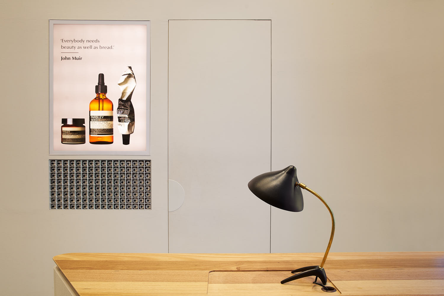 Aesop store counter top with a minimalist lamp in warm interior lighting.