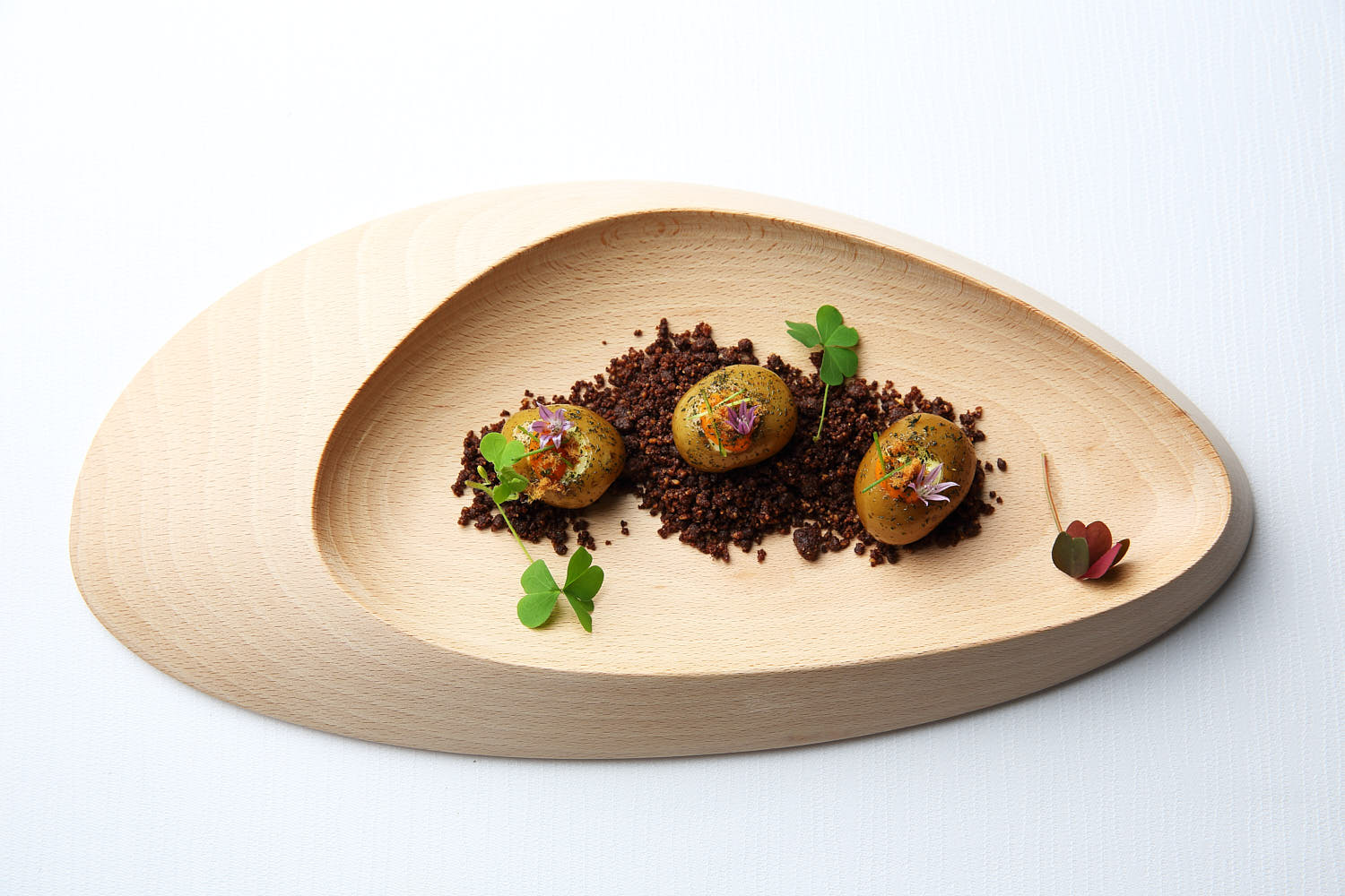 Minimalist fine dining dish showcasing abstract plating with vibrant ingredients and geometric elements.