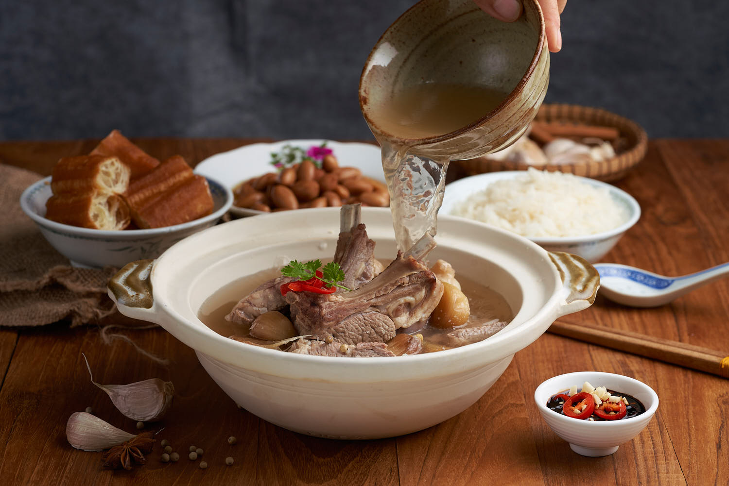 Authentic Bak Kut Teh with succulent pork ribs and a rich herbal broth, served in a clay pot.