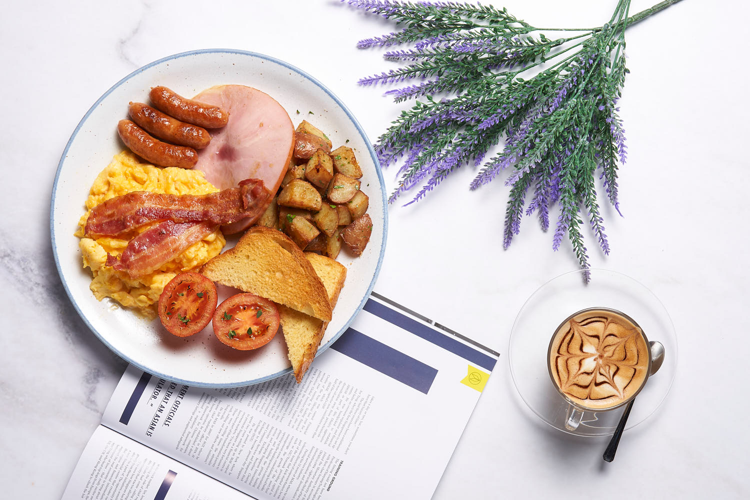 Buttered toast with scrambled eggs, crispy bacon, potato, sausage and tomatoes on a rustic wooden board.