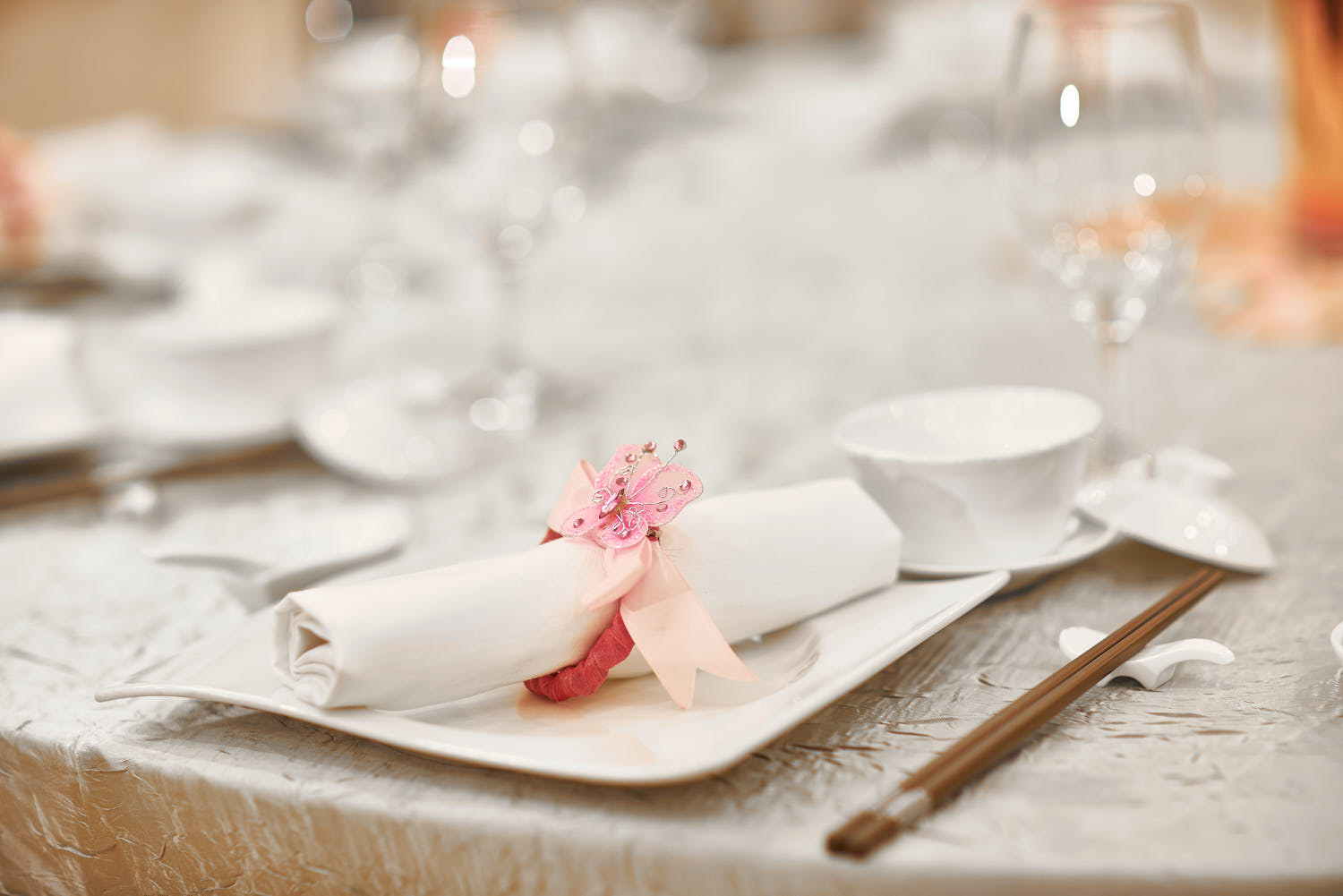 Butterfly motif decoration on a wedding dinner table in a hotel setting.