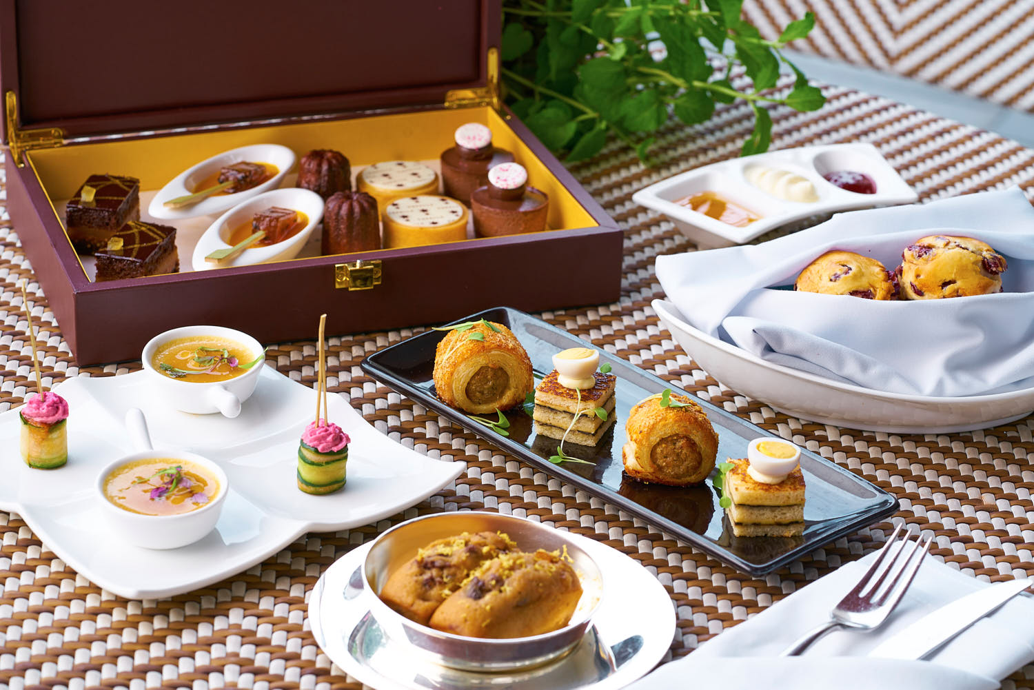 Luxury afternoon tea platter with delicate pastries, finger sandwiches, and artisanal jam.