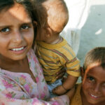 An older sister lovingly takes care of her younger siblings in Charsadda, Pakistan, August 2010.