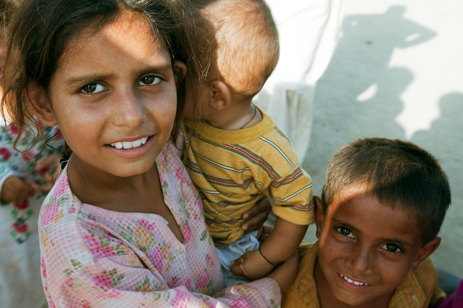 An older sister lovingly takes care of her younger siblings in Charsadda, Pakistan, August 2010.