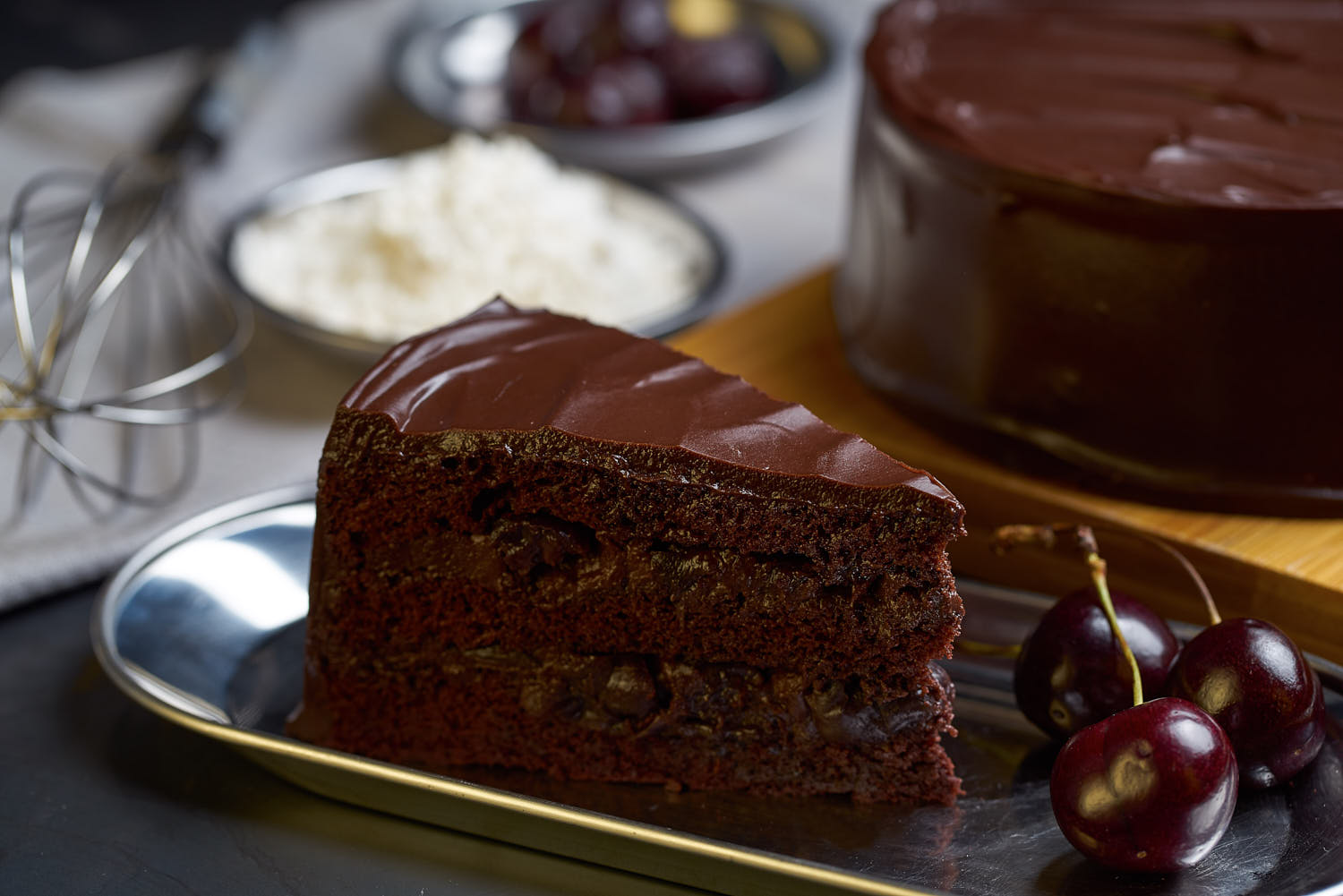 Intimate shot of a decadent cherry chocolate cake with creamy layers and a smooth glaze.