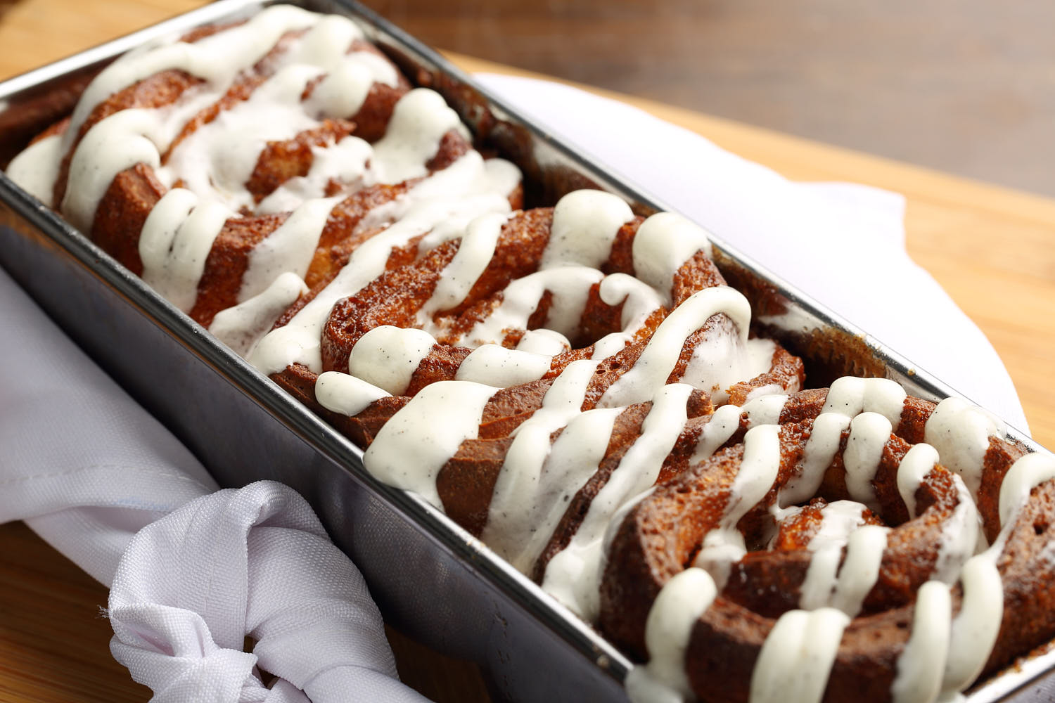 Cinnamon baked bread with vanilla sauce.