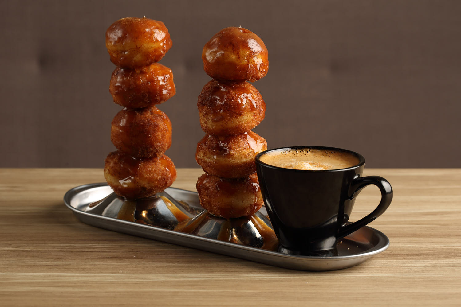 Cinnamon balls dessert coated in caramel syrup with coffee.