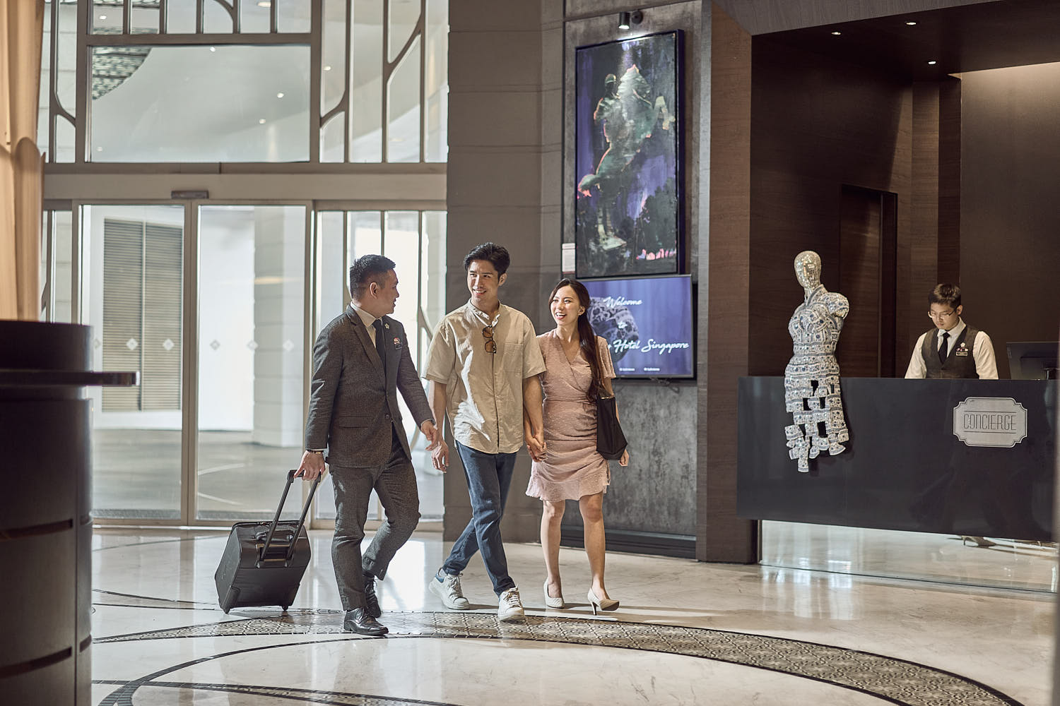 Concierge warmly welcoming guests to a luxurious 5-star hotel.