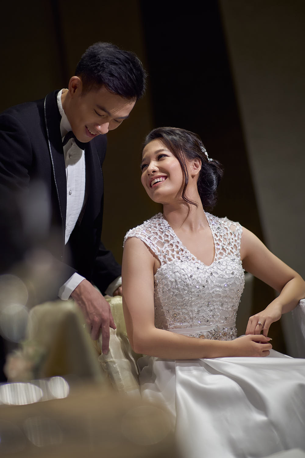 Bride appreciating a romantic gesture from the groom during their wedding celebration.