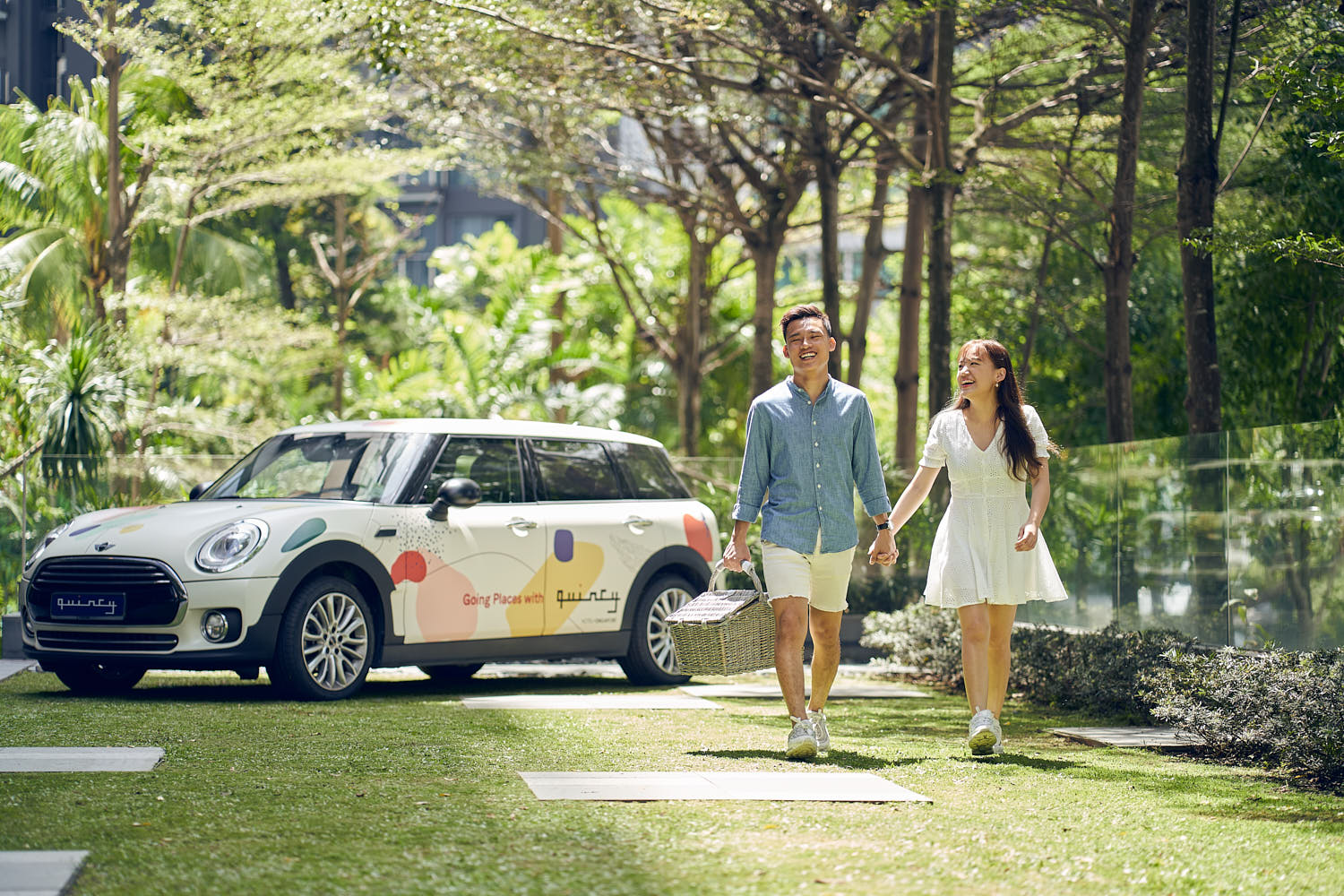 Couple strolling hand-in-hand, enjoying a scenic walk along the hotel lawn.