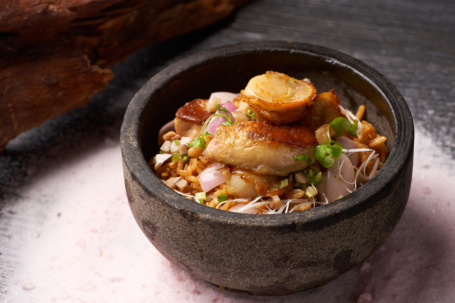 Crystal Jade's luxurious fried rice with perfectly seared scallops and rich foie gras garnished with herbs.