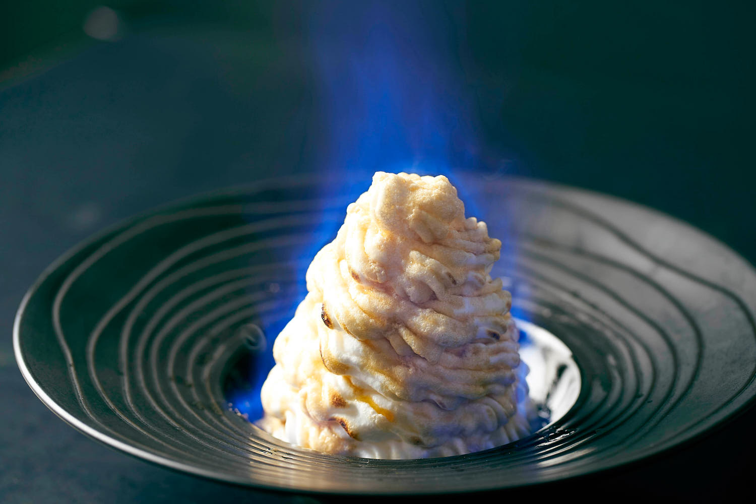 Baked Alaska with a flaming meringue topping.