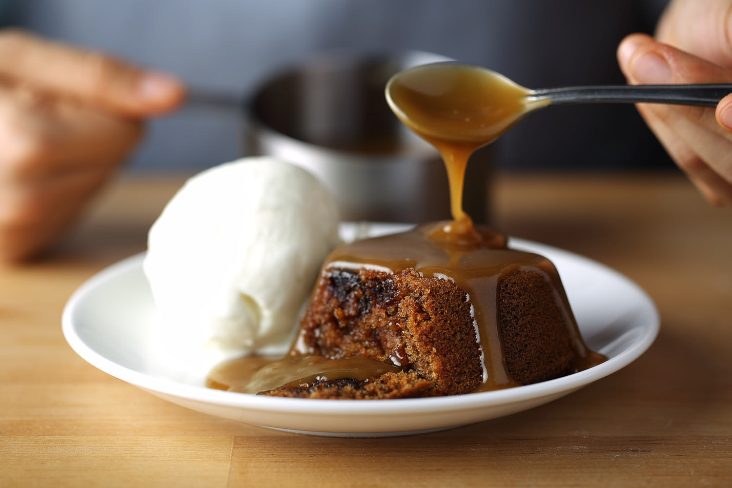 Lava cake with vanilla ice cream accompanied by dash of caramel sauce.