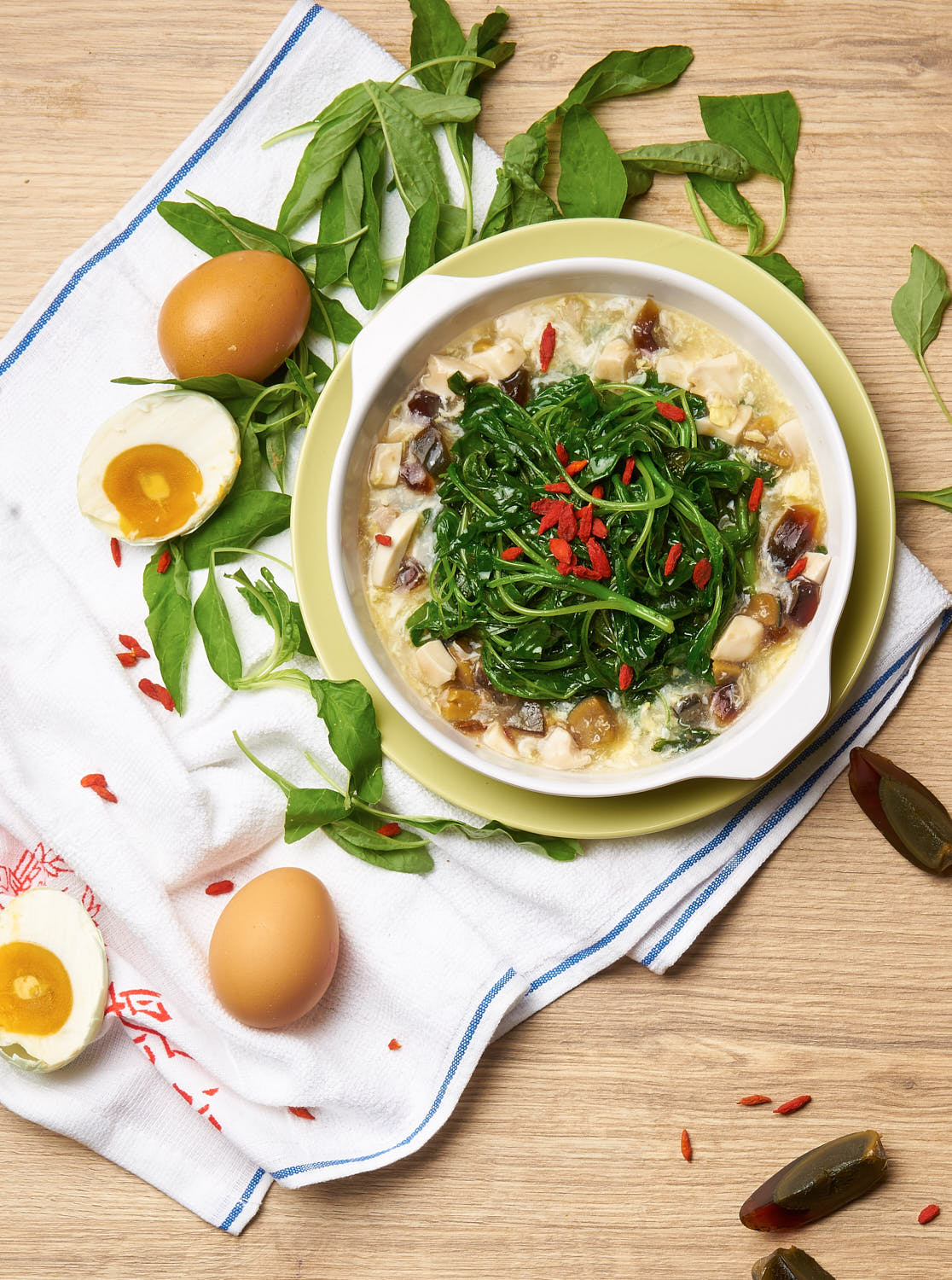 Spinach dish with assorted eggs topped with wolfberries.