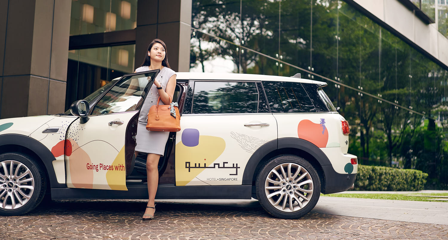 Elegant woman arriving at a luxurious hotel lobby, ready for a premium experience.