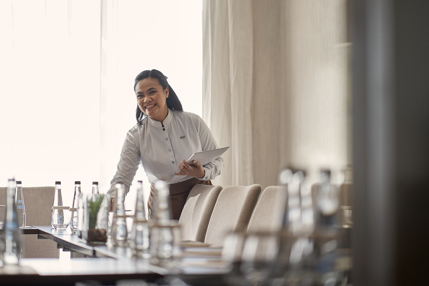 Event team setting up a conference room in a hotel for a professional event.