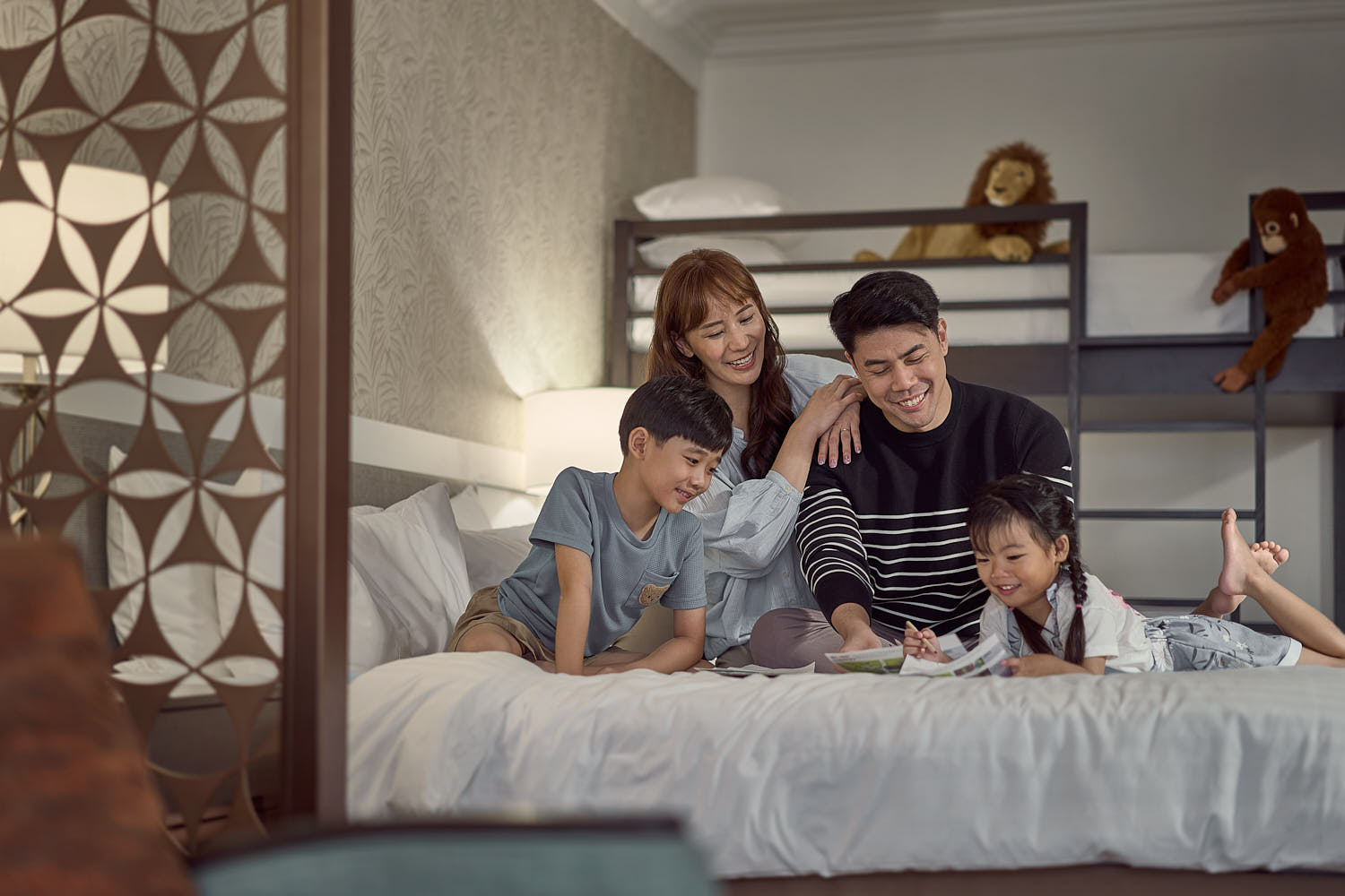 Happy family spending quality time and making memories in a resort room.