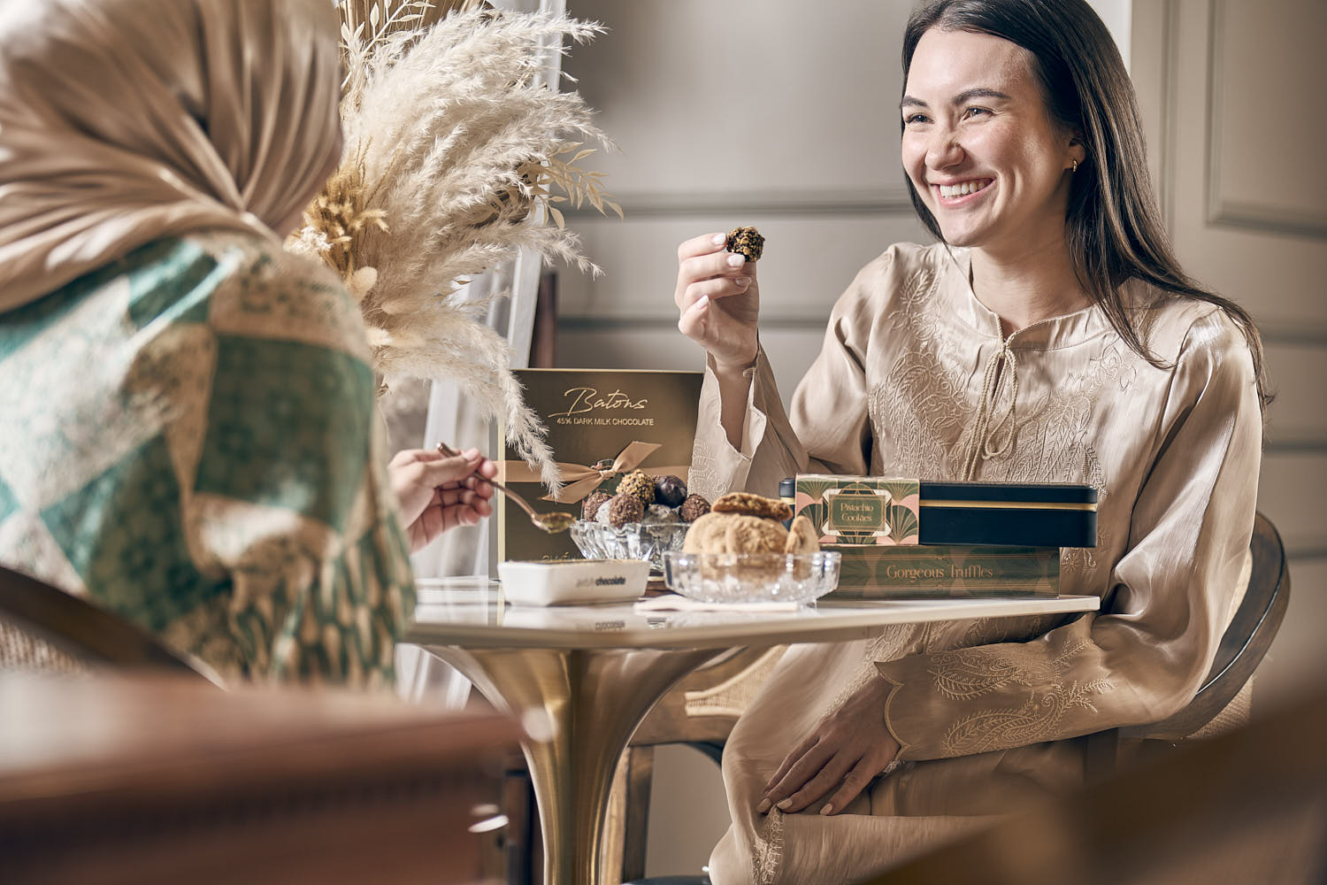 Friends sharing decadent desserts at a luxury restaurant for a special celebration.