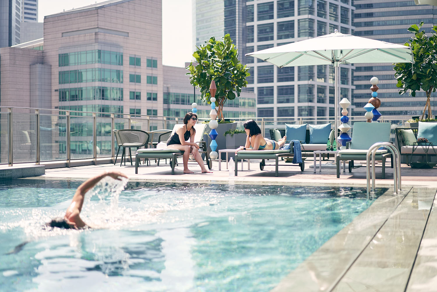 Friends enjoying a luxurious infinity pool experience at a five-star hotel.
