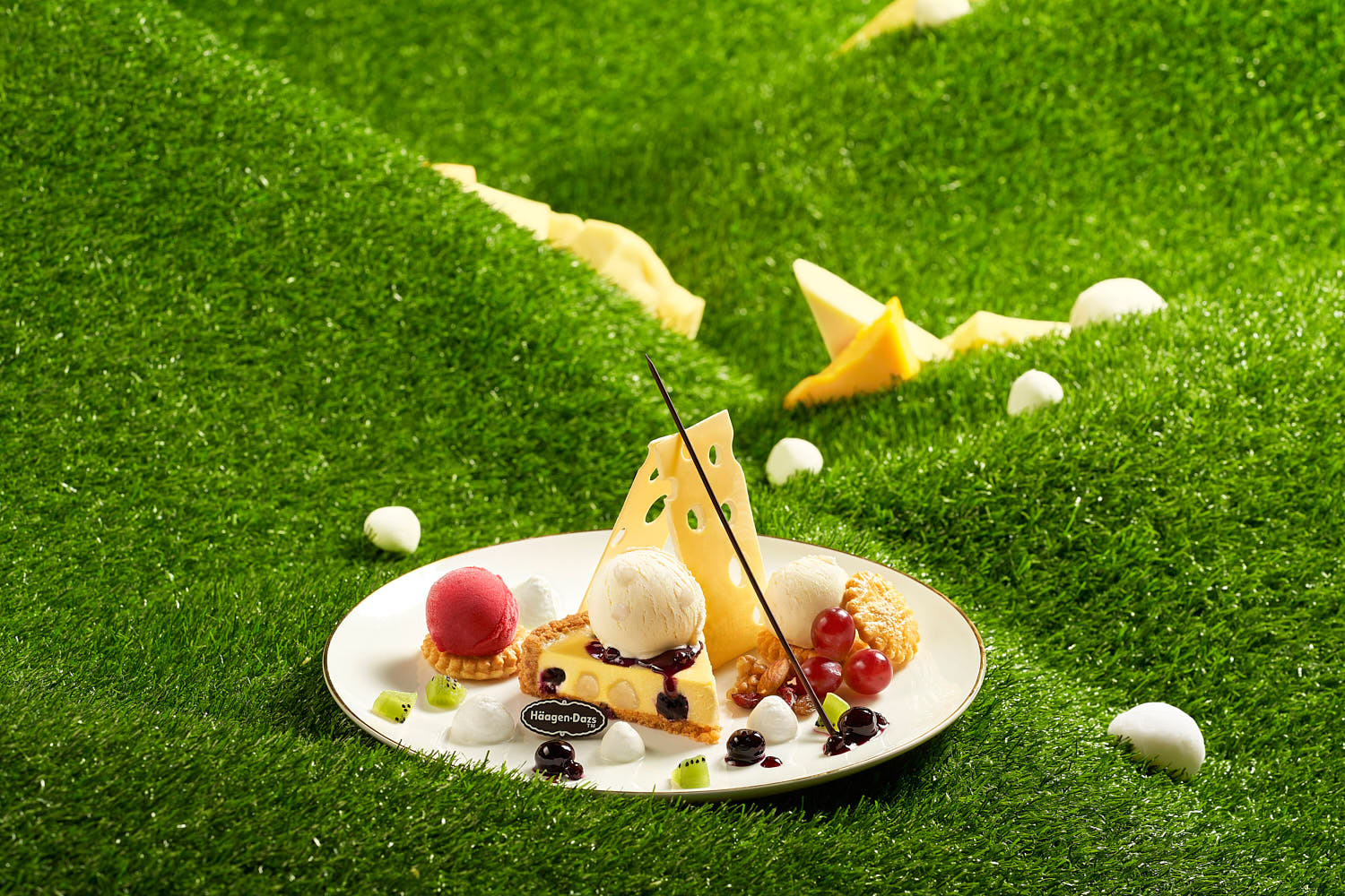 Green Hills-inspired cheesecake topped with fresh fruit, served with a scoop of mochi vanilla ice cream on the side.