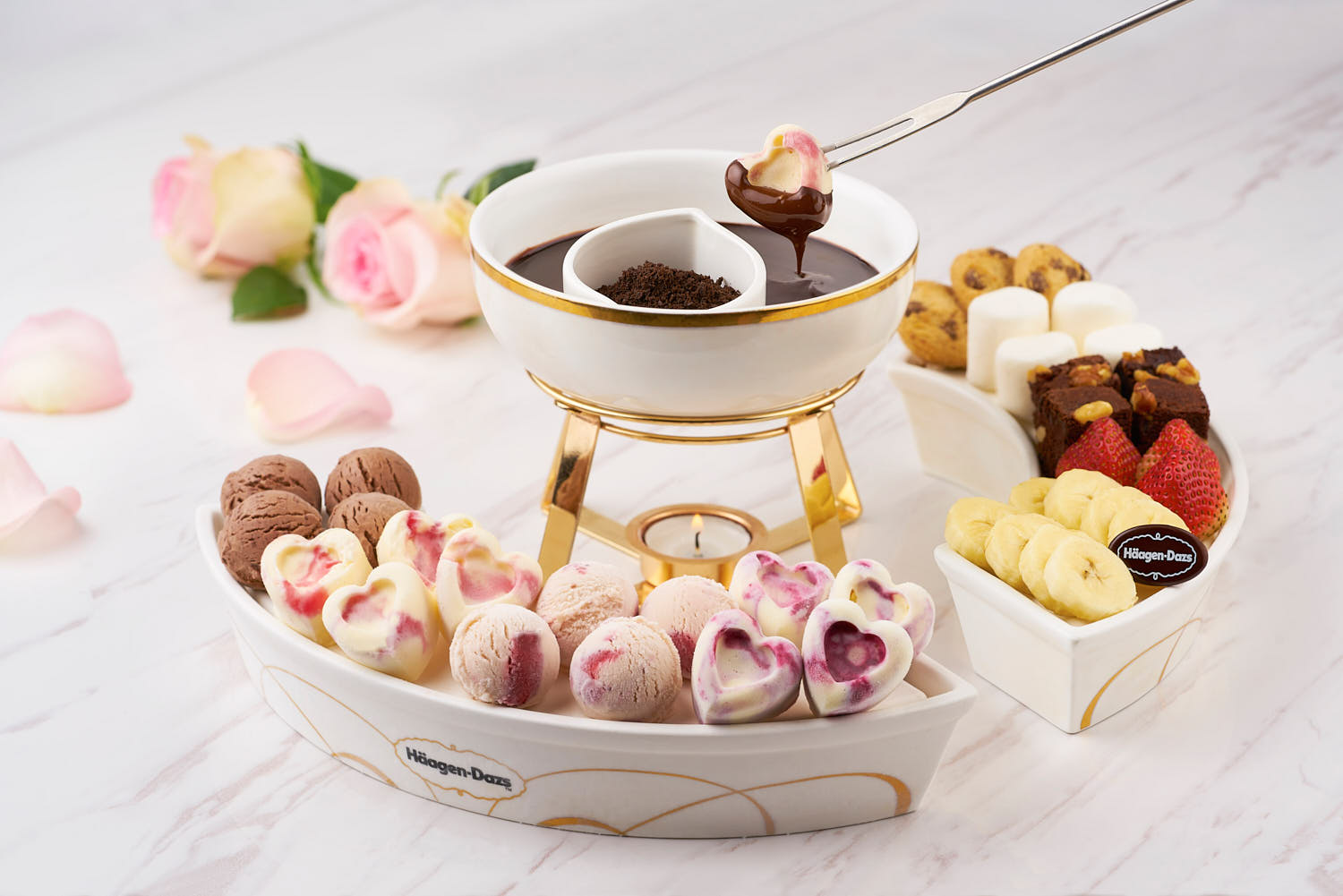 A selection of mini ice cream scoops (vanilla, chocolate, strawberry) served with melted chocolate for dipping.