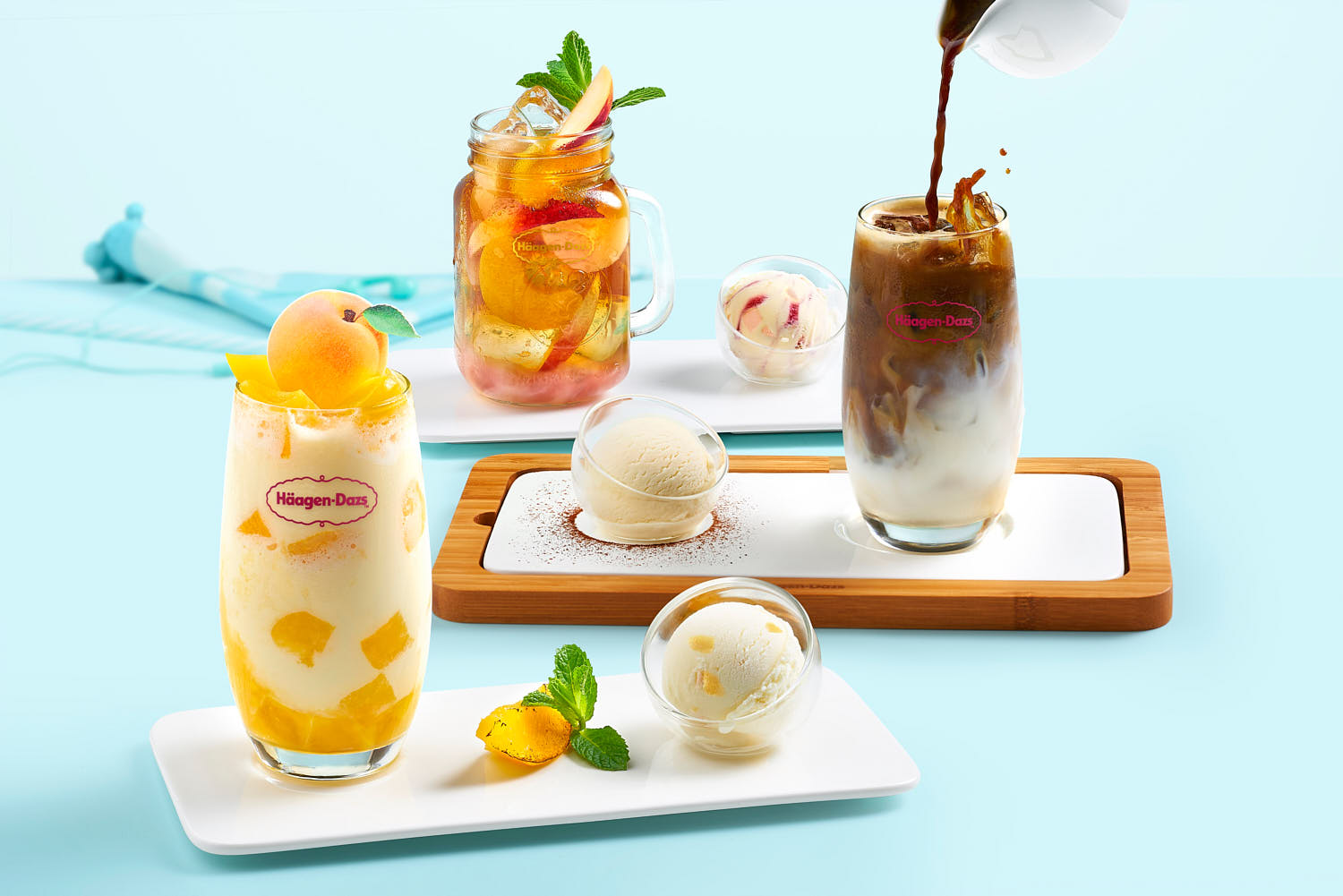 Assorted Häagen-Dazs ice cream scoops paired with a selection of refreshing drinks, including iced coffee, fruit tea, and peach shake.