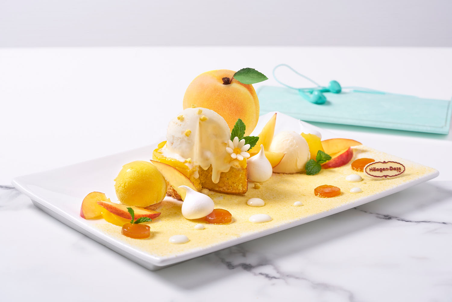 Profile lifestyle shot of peach flavours, styled with fresh mint, peach slices, and a hint of sugar crystals.