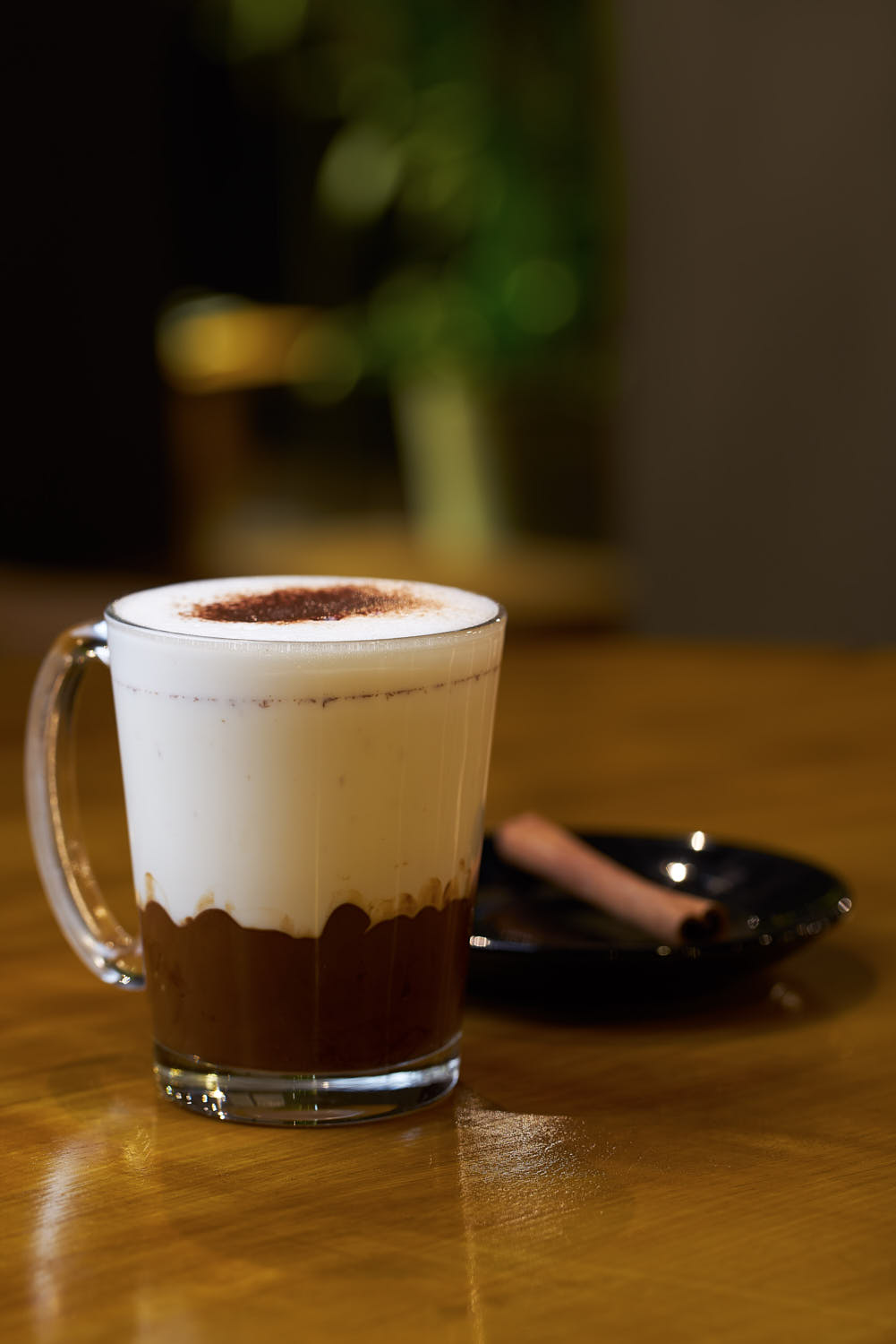 Thick hot chocolate with cinnamon stick.