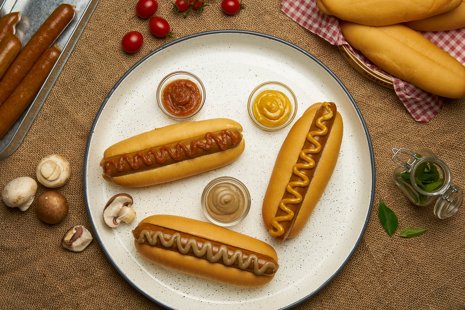 Hot dog with a variety of sauce in a rustic setting.