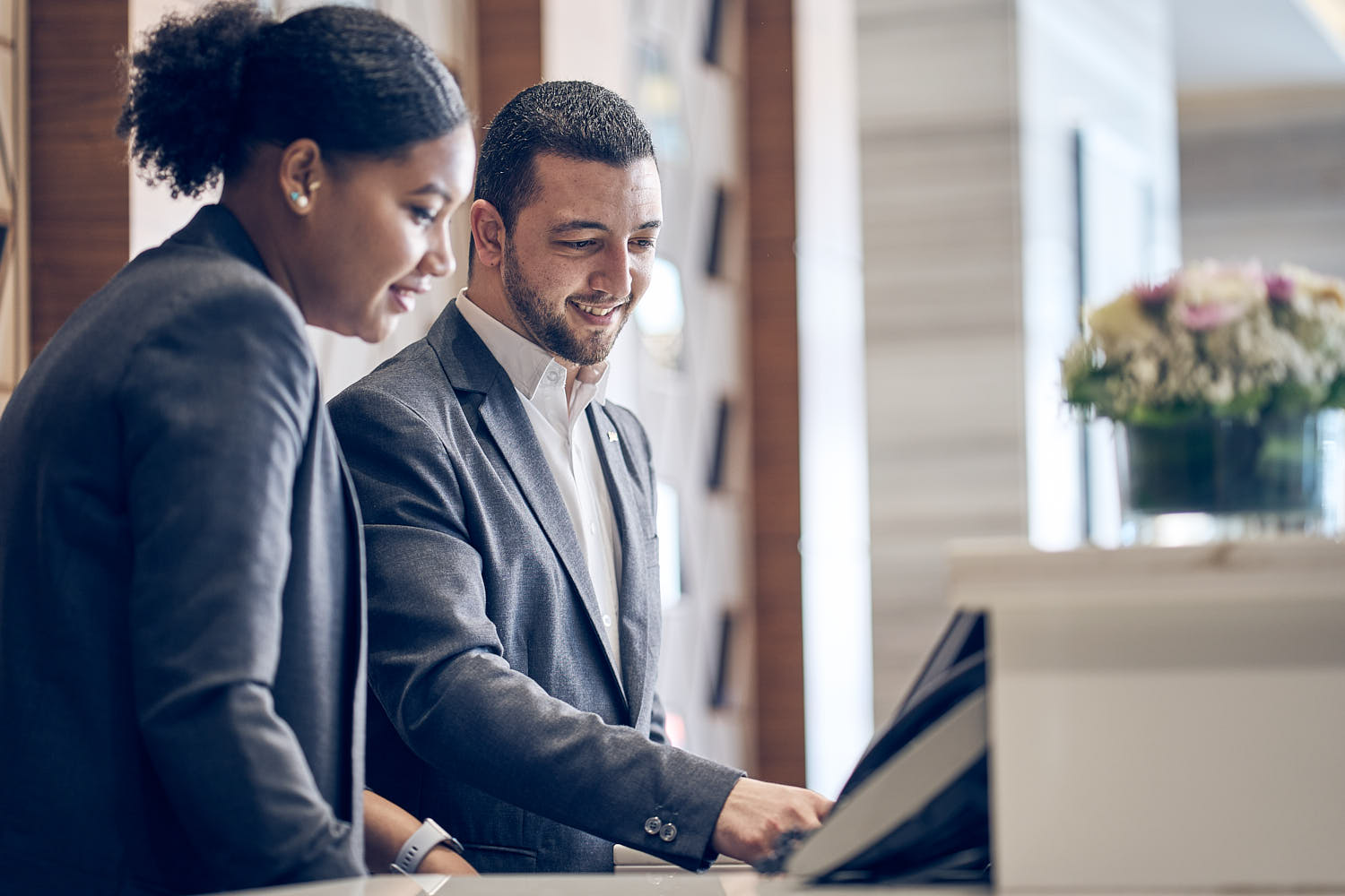 Hotel general manager having a conversation with the team in the lobby area.