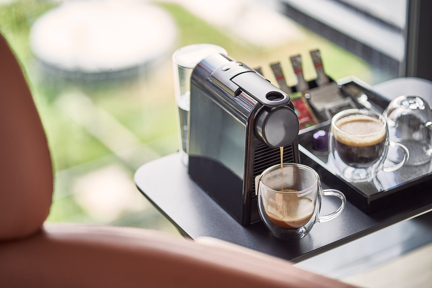 Close-up of a coffee maker in a hotel room interior.