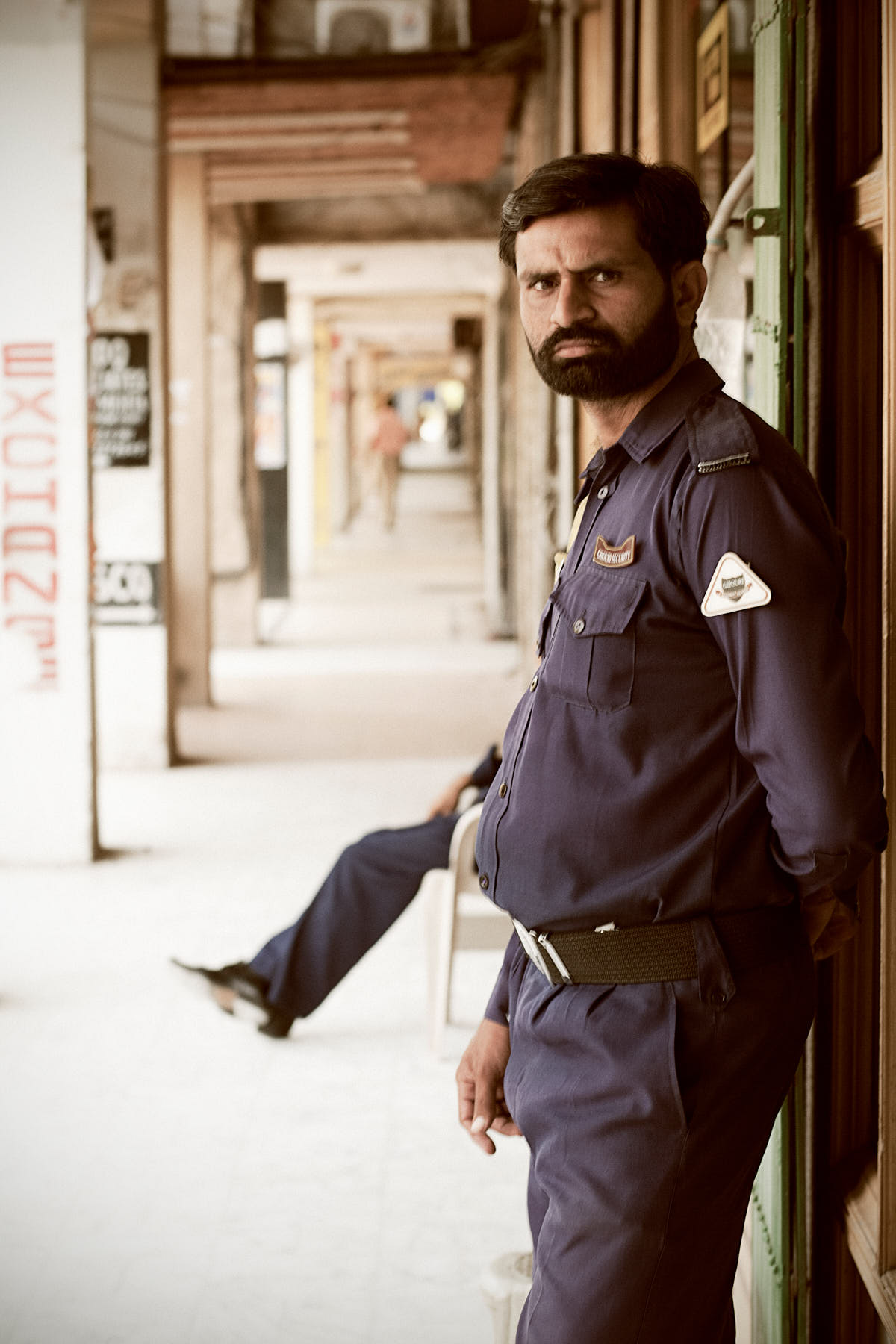Armed security guards stationed outside local shops in Islamabad, Pakistan, August 2010, following Taliban threats to kidnap aid workers.