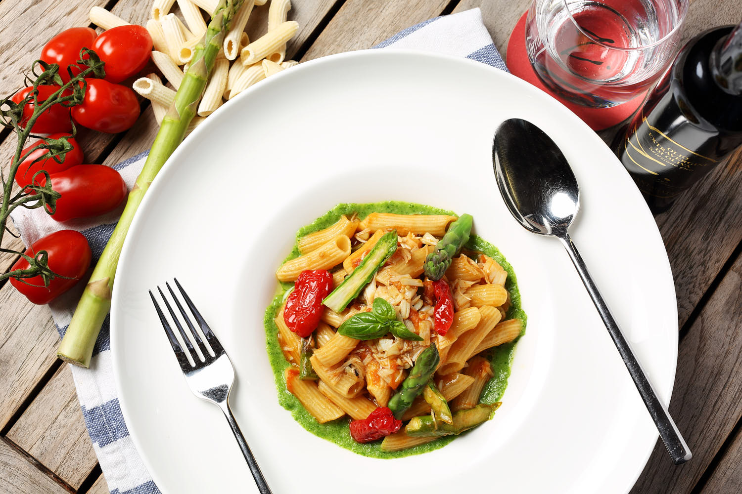 Delicious penne pasta in a creamy sundried tomato and pesto sauce, garnished with fresh basil.