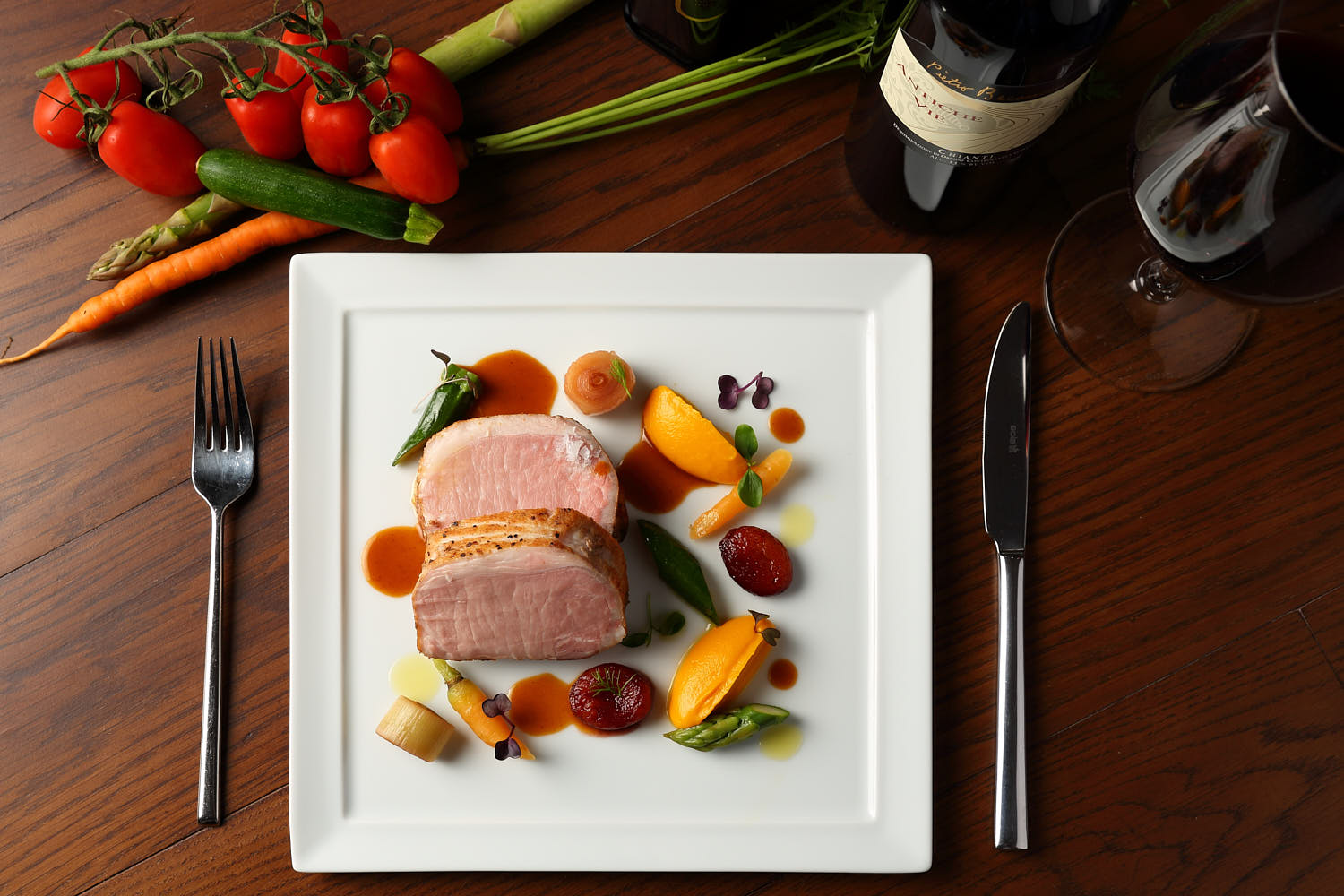 Top down artistic arrangement of ham and garnishes.