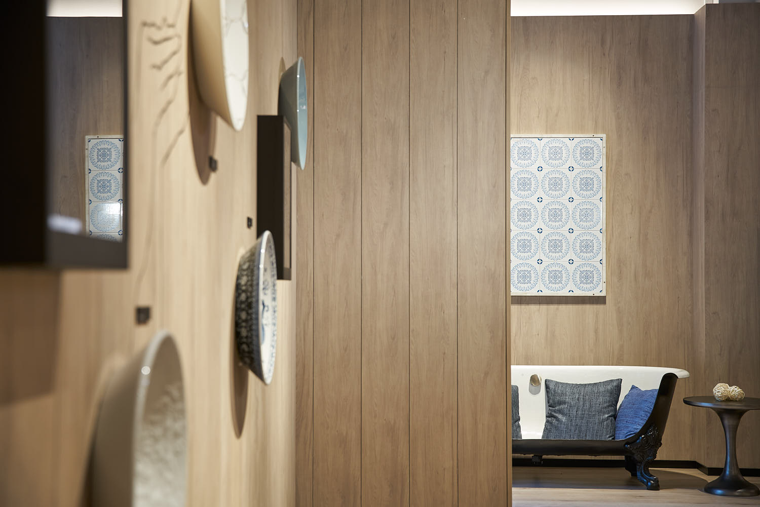 Creative bathtub repurposed as a sofa at the Kohler Experience Center interior display.