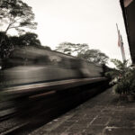 Fine art photo of a KTM train in motion blur passing Bukit Timah Railway Station, Singapore.