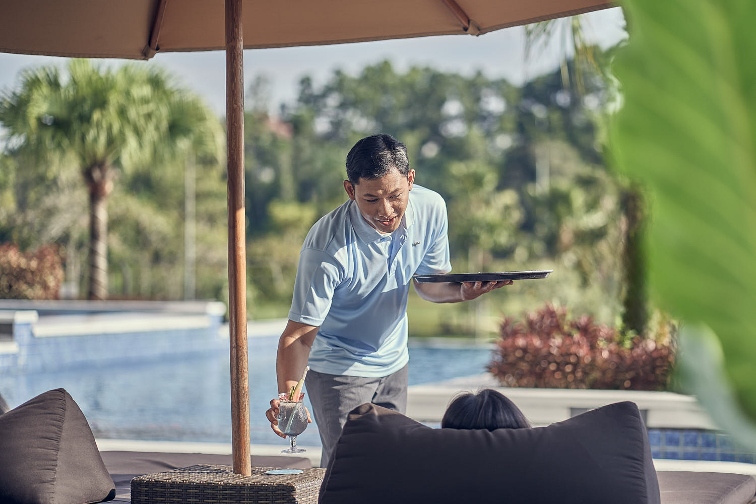 Infinity pool experience at a resort with a guest enjoying panoramic mountain views.