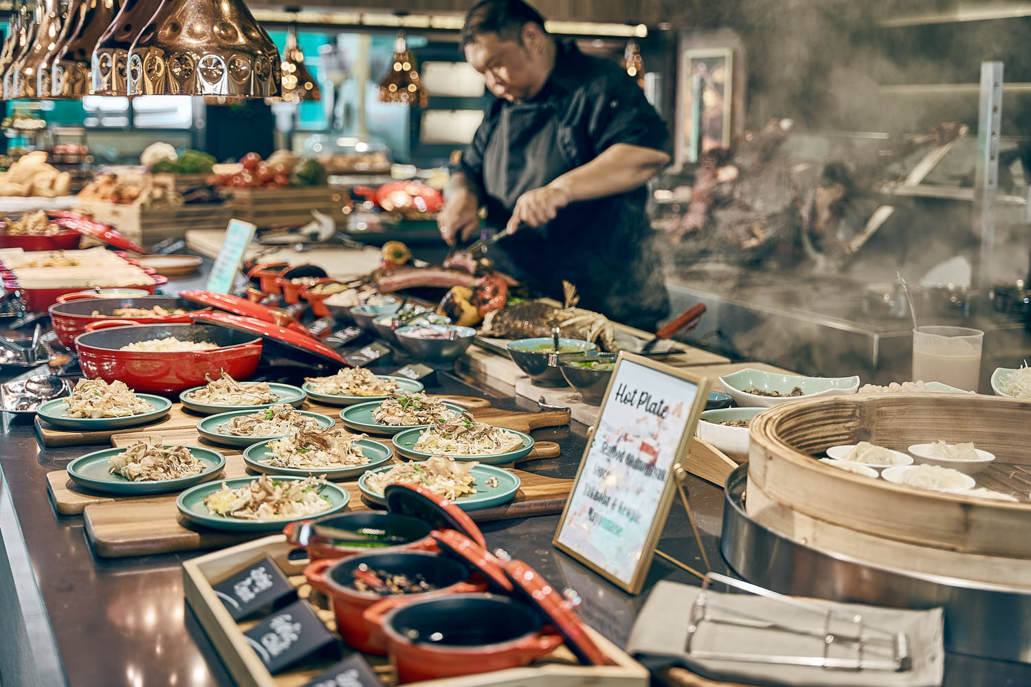 International buffet spread with diverse dishes displayed at Mercure ICON hotel.