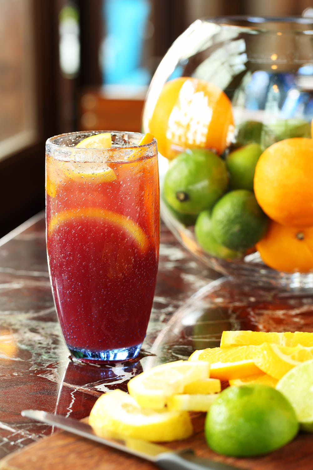 Refreshing mixed fruit cooler served in a tall glass with vibrant fruit pieces.