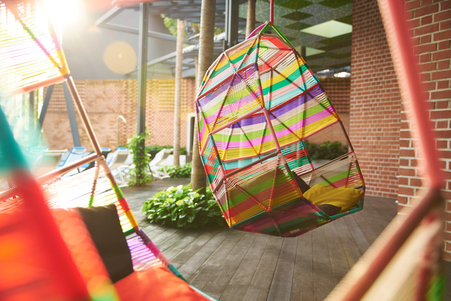 Rooftop relaxation area at Oasia Hotel with lounge chairs and skyline view.