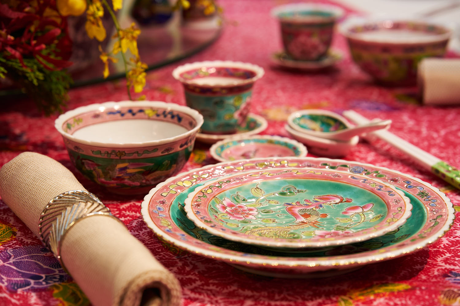 Peranakan-style wedding setup in a hotel venue with traditional décor elements.